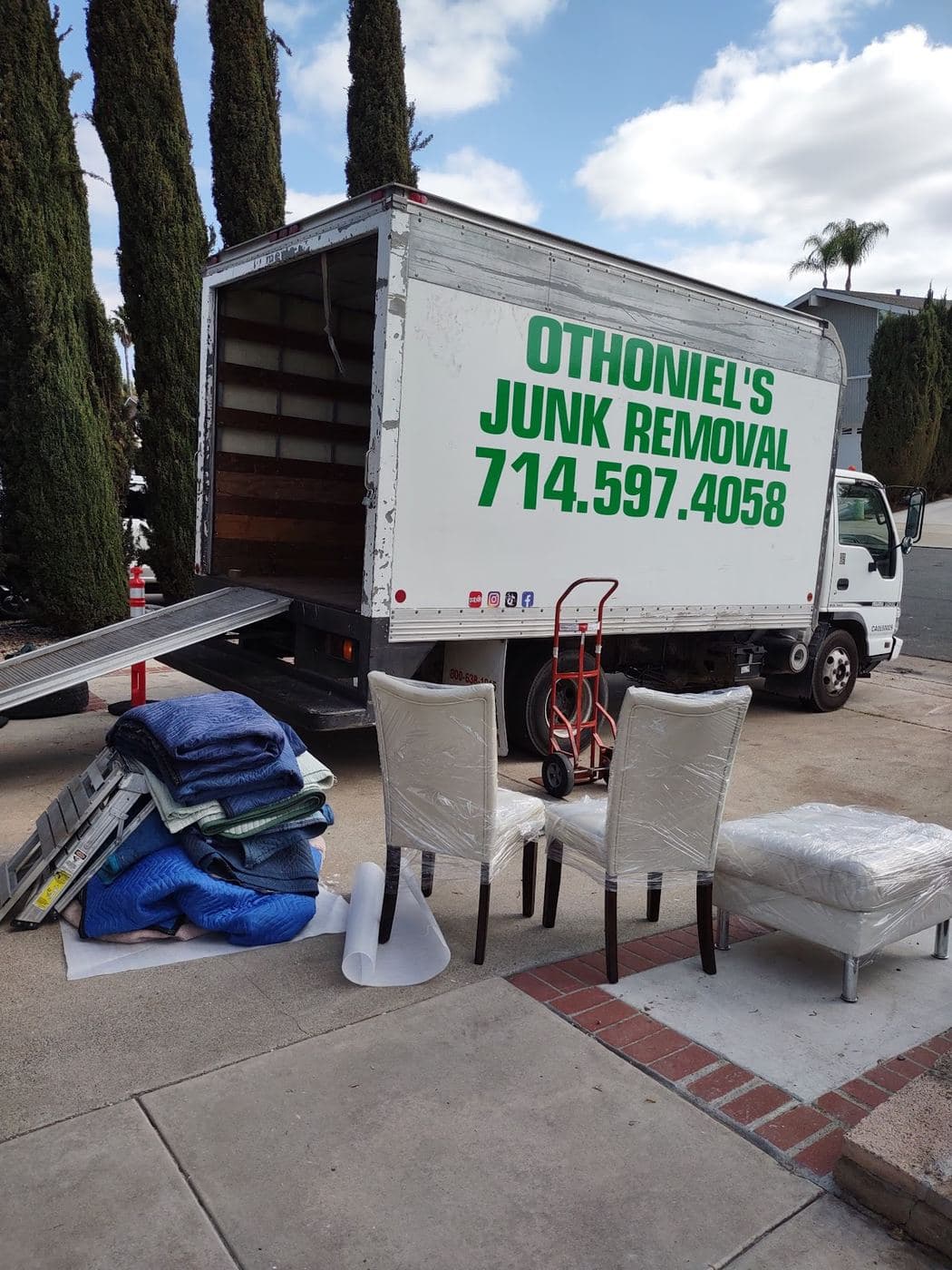 Othoniel's Junk Removal box truck loaded with furniture ready for pickup